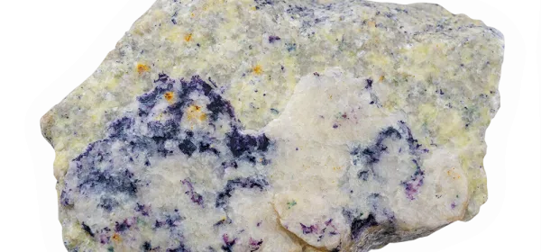 Fluorite-rich granite specimen with striking purple fluorite crystals embedded in light granite matrix, displayed on a wet surface.