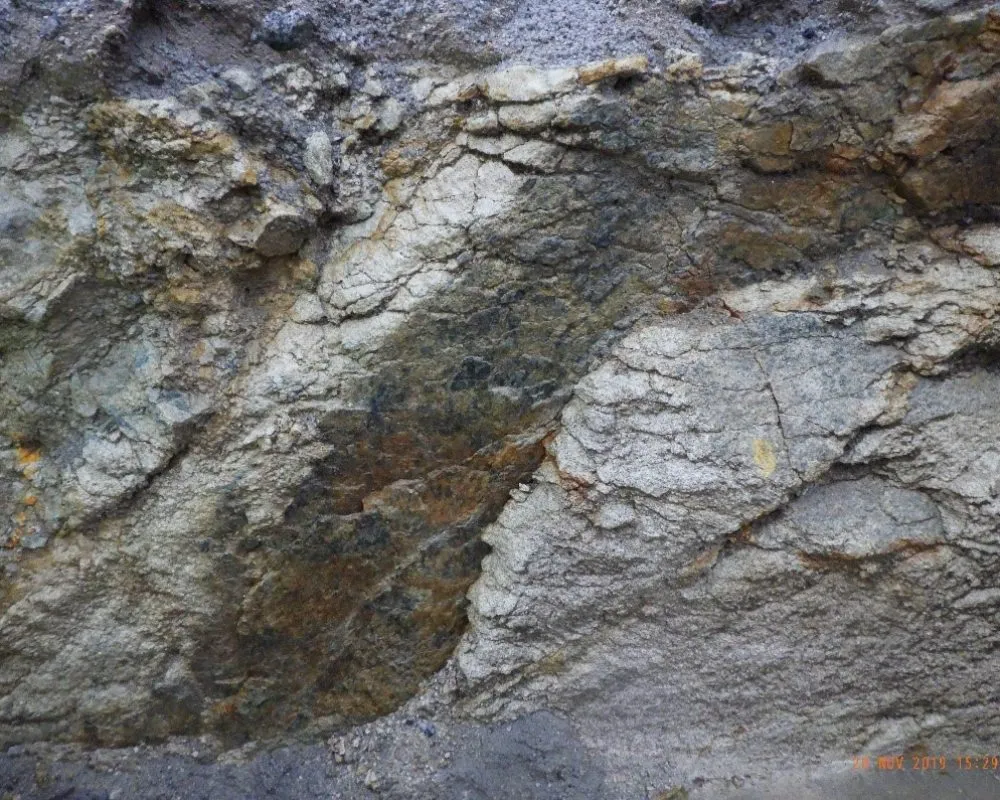 Close-up of exposed mineral vein in rock formation, showing lithium-bearing granite typical of Cornwall geology.