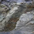 Close-up of exposed mineral vein in rock formation, showing lithium-bearing granite typical of Cornwall geology.